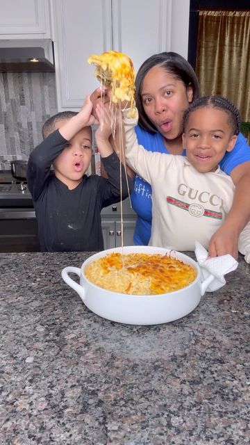 three children and an adult posing for a photo in front of a casserole dish