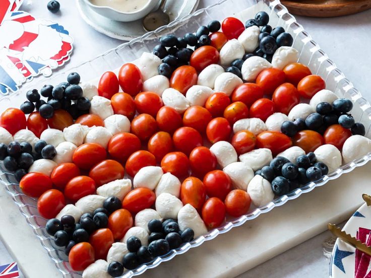 an american flag made out of tomatoes and blueberries