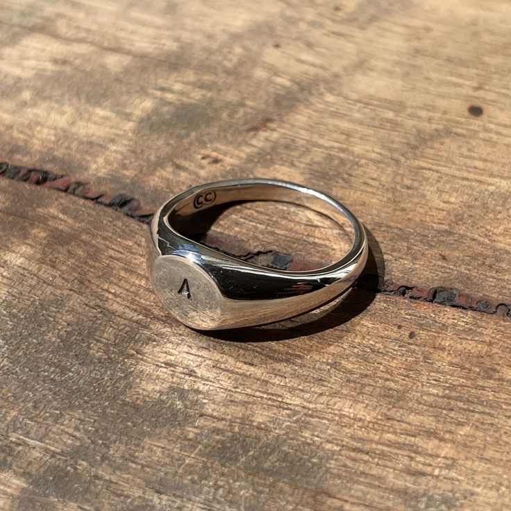 Make it personal... A classic small circle signet ring hand-stamped with your desired initial. Simply enter the letter of your choice in the order notes. These timeless signet rings are meticulously crafted by hand in our Melbourne workshop, created out of wax and then cast into precious metal. Made with the highest quality Australian sterling silver to last forever. Made solid, not hollow like many others, all of our rings are hand-stamped with a Sterling Silver (925) hallmark and Custom Creed Timeless Ring, Signet Rings, Ring Hand, Small Circle, Black Ribbon, Precious Metal, Perfectly Imperfect, Signet Ring, Makers Mark