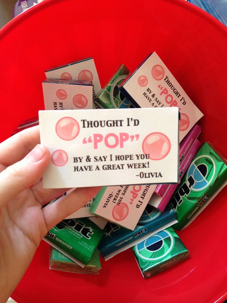 a red bowl filled with lots of different types of candy and wrappers on top of each other