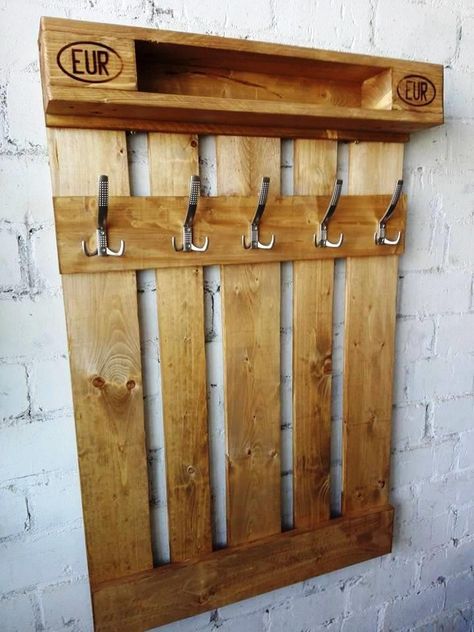 a wooden coat rack with hooks on it