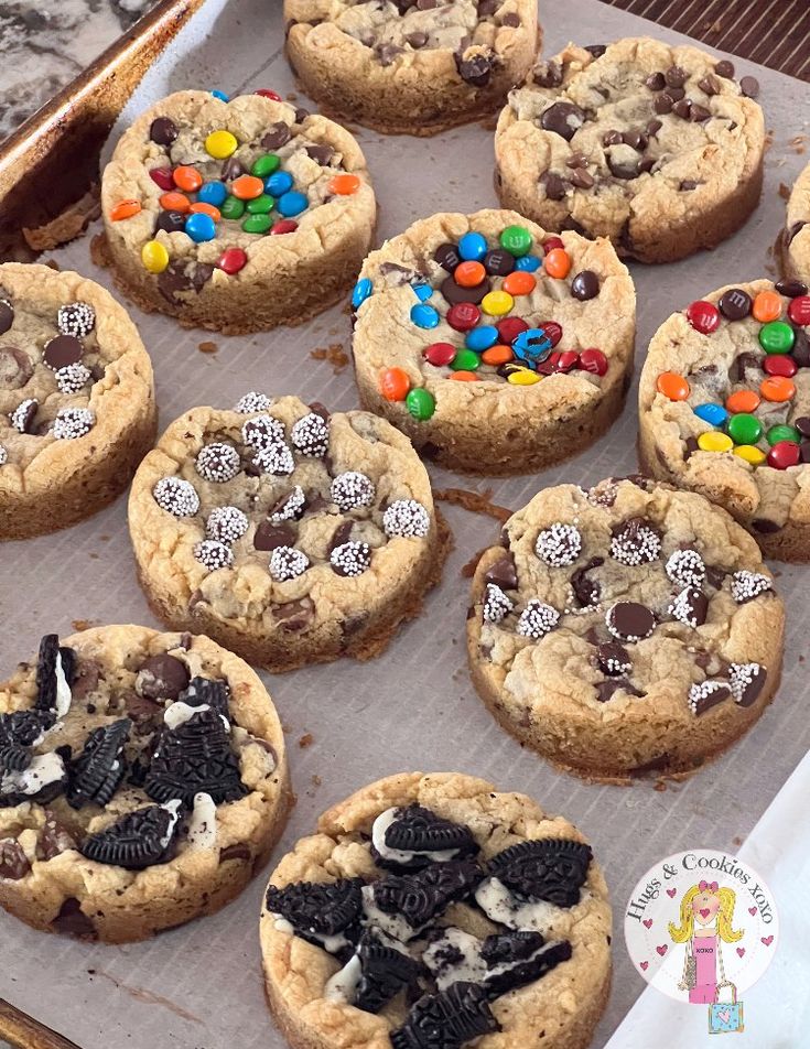 chocolate chip cookies with m & m's and oreos are on a baking sheet