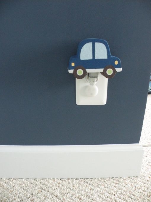 a blue car light switch cover on the wall