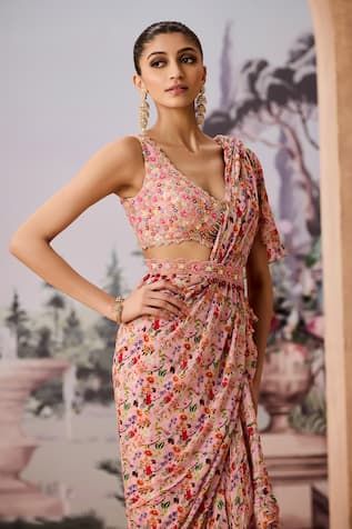 Peach pre-draped ruffle saree in floral chintz print and frilled tiers. Comes with sequin, bead and pearl embellished padded blouse. Paired with scalloped embellished belt. - Aza Fashions Draped Georgette Dresses For Diwali, Floral Print Dress With Traditional Drape For Party, Floral Print Summer Dress For Reception, Summer Floral Print Dress For Reception, Summer Reception Draped Dress, Summer Party Pre-draped Saree, Summer Georgette Pre-draped Saree For Reception, Draped Dress For Diwali Reception, Draped Reception Dress For Diwali