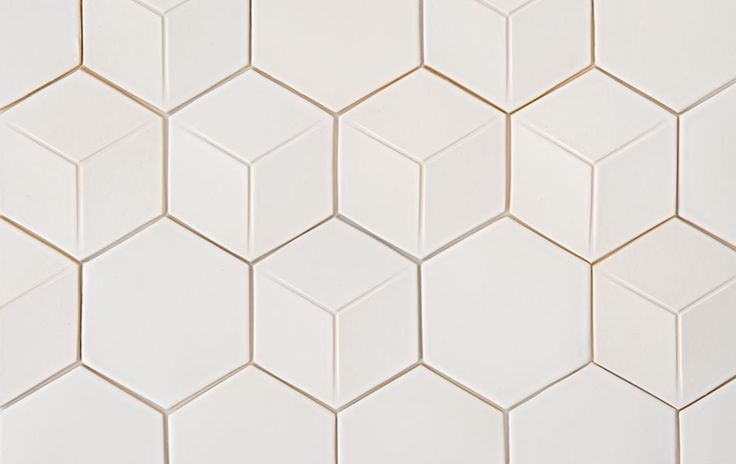 white hexagonal tiles are arranged in an angled pattern, with one corner facing the other