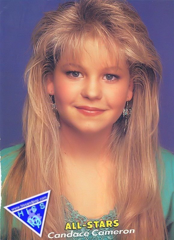 a woman with long blonde hair and blue eyes is smiling at the camera while wearing earrings