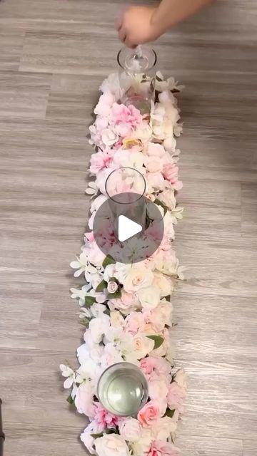 someone is placing flowers on the floor to decorate it with candles and tea lights for an elegant touch