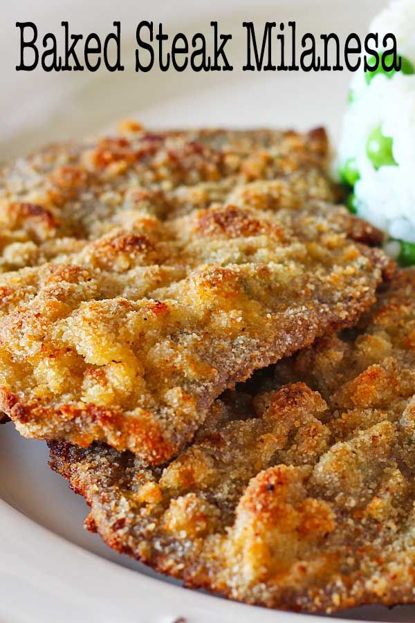 three pieces of breaded steak on a white plate