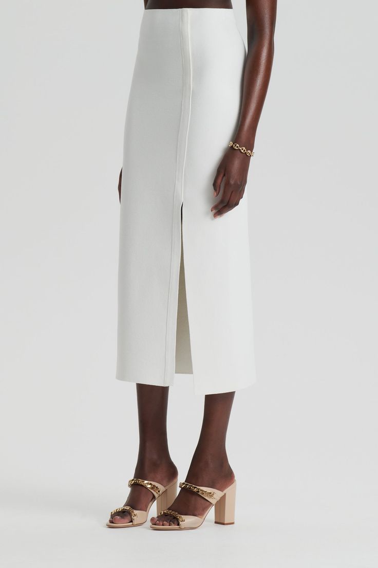 The Crepe Knit Split Skirt is imbued with modern minimalism and sophistication. Crafted from Scanlan Theodore's signature Crepe Knit fabrication, the minimalist silhouette is tailored to a mid-calf length and features a side split and exposed seam detailing. Elevate workwear styling by pairing the skirt with complementary Crepe Knit pieces, or pair it with a feminine blouse for upcoming occasions. Scanlan Theodore, Buy Skirts, Minimalist Silhouette, Feminine Blouses, Split Skirt, Fine Yarn, Modern Minimalism, Australian Fashion, Side Split