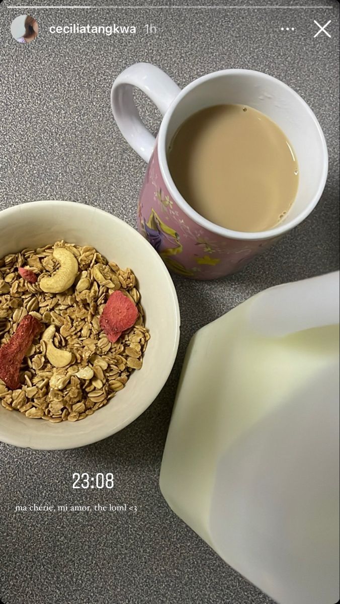 a bowl of granola next to a cup of coffee