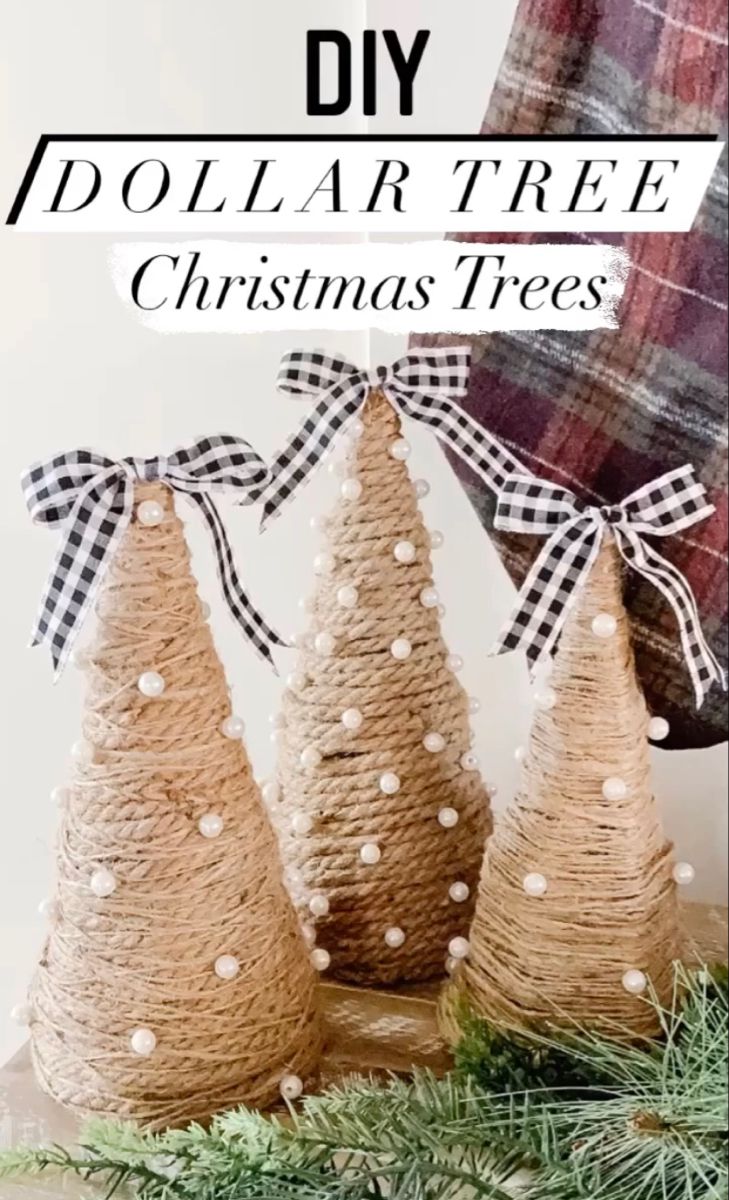 three burlap christmas trees with black and white bows on them, sitting next to each other