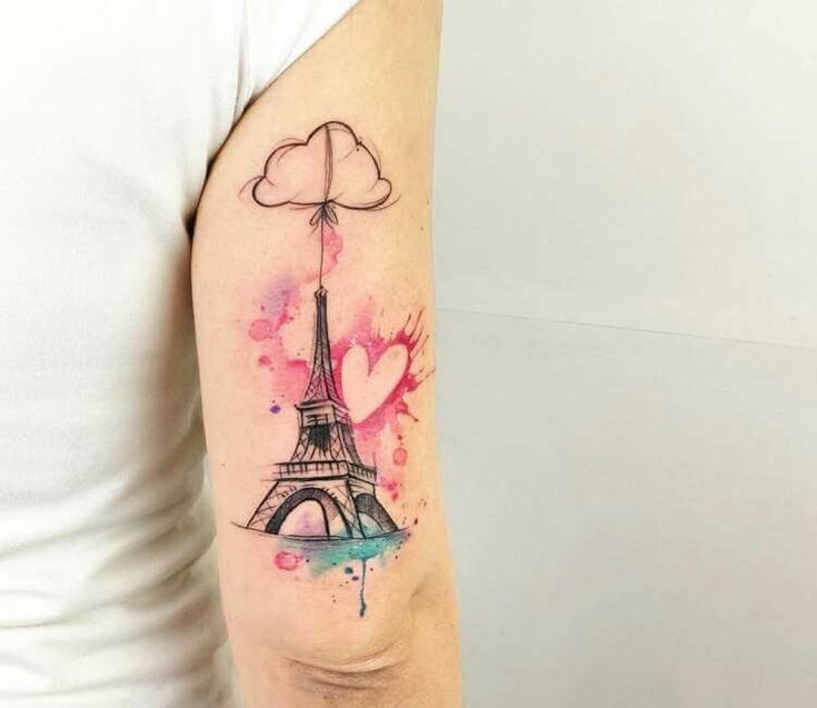 a woman's arm with the eiffel tower tattoo on it