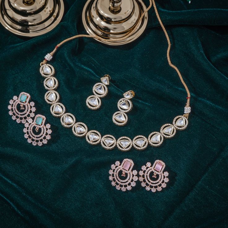 Step-in to the aura of timeless elegance with this must-have piece adding a touch of class to any ensemble! Embellish your look with subtle sophistication and enhance your style with this exquisite set crafted with luxurious and dazzling polki jadau kundan stones. The set includes a necklace and a pair of push-back earrings. Approximate earrings length is 1.5". Gold-plated on high-quality brass as base metal. In-stock & ready-to-ship. *Please Note: We use faux stones and beads in all of our jewe