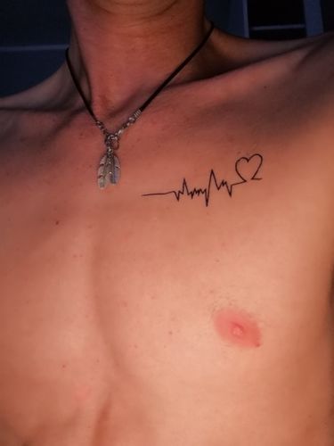 a man with a heartbeat tattoo on his chest