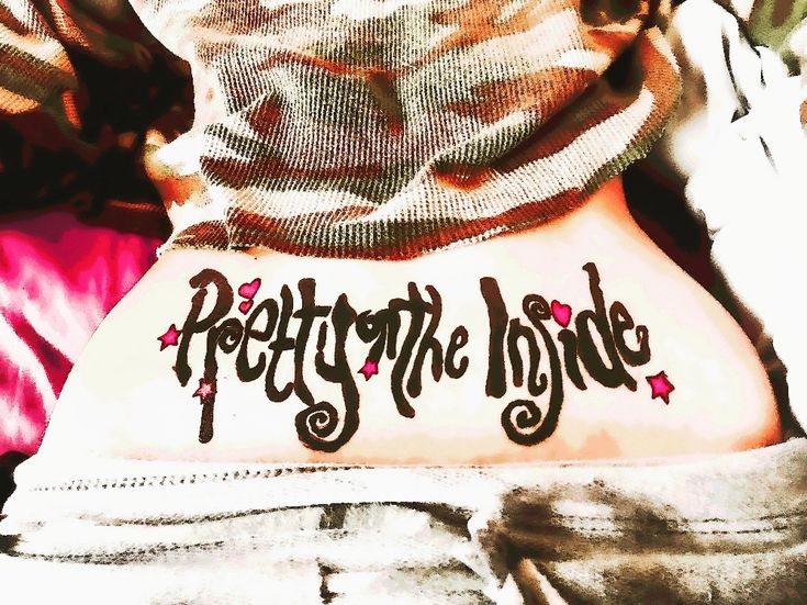 the back of a person's stomach with writing on it that says pretty to the inside