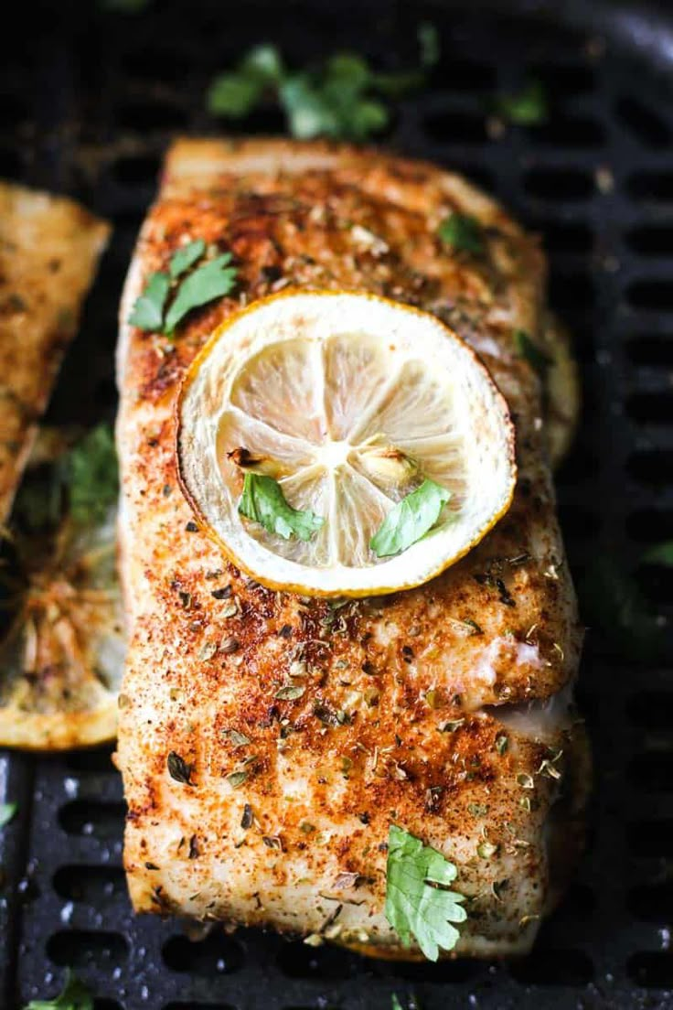 grilled salmon with lemon and herbs on the grill