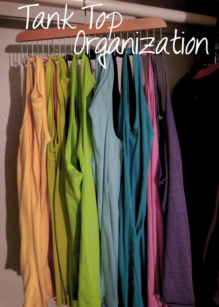 there are many different colored shirts hanging on the rack