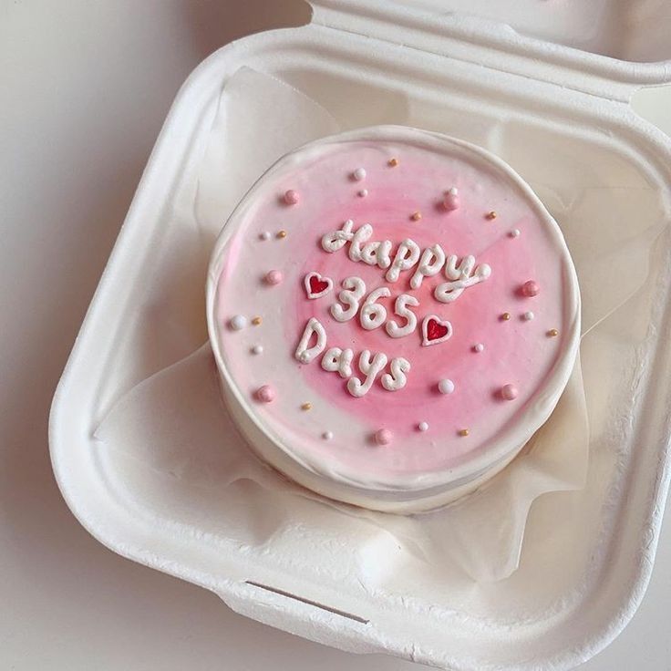 a cake in a foam container with the words happy 365 days on it and hearts