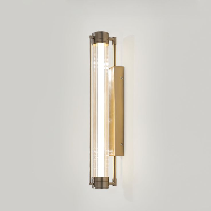 a wall mounted light on the side of a white wall