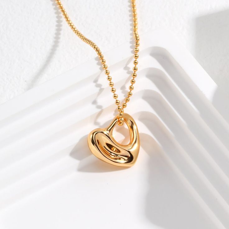 Embrace the timeless elegance of this beautiful heart-shaped pendant necklace, crafted from premium 925 sterling silver and finished with a lustrous 14k gold plating.  The centerpiece of this stunning piece is a sleek, modern heart-shaped pendant, measuring approximately 17mm in size. The simple yet striking design allows the natural shine and beauty of the gold plated sterling silver to take center stage, creating a refined, minimalist look. Whether you're dressing up for a special occasion or Tarnish Resistant Heart Pendant Necklaces For Mother's Day, Luxury Sterling Silver Heart Charm Necklace, Elegant Polished Necklace For Her, Classic Heart Pendant Necklace For Her, Gold Sterling Silver Heart Choker Necklace, Luxury Open Heart Necklace For Gift, Luxury Open Heart Necklace - Gift, Tarnish Resistant Yellow Gold Heart Necklace For Her, Elegant Sterling Silver Heart Necklace With Polished Finish