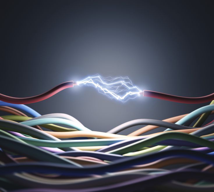 an abstract image of colorful lines and wires in the air with a bright light above them