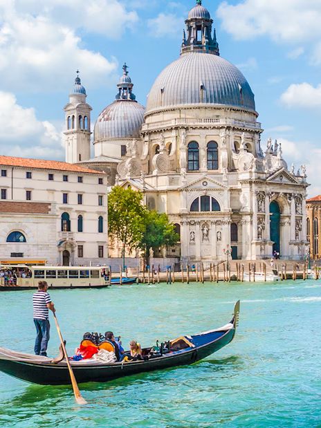 a gondola with people on it in front of a large building