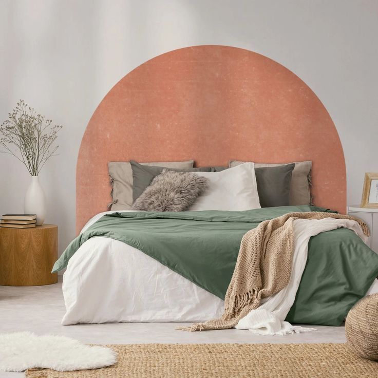 a bedroom with an orange headboard and green bed linens on the bottom half