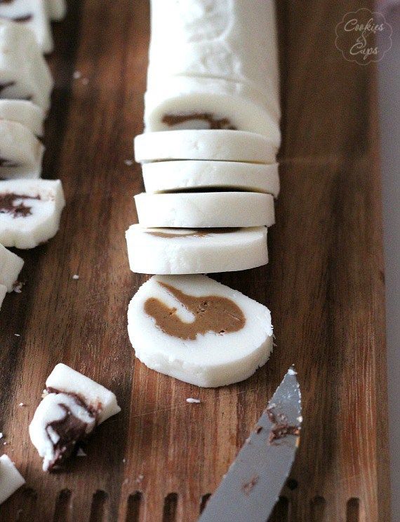 sliced up pieces of food sitting on top of a wooden cutting board