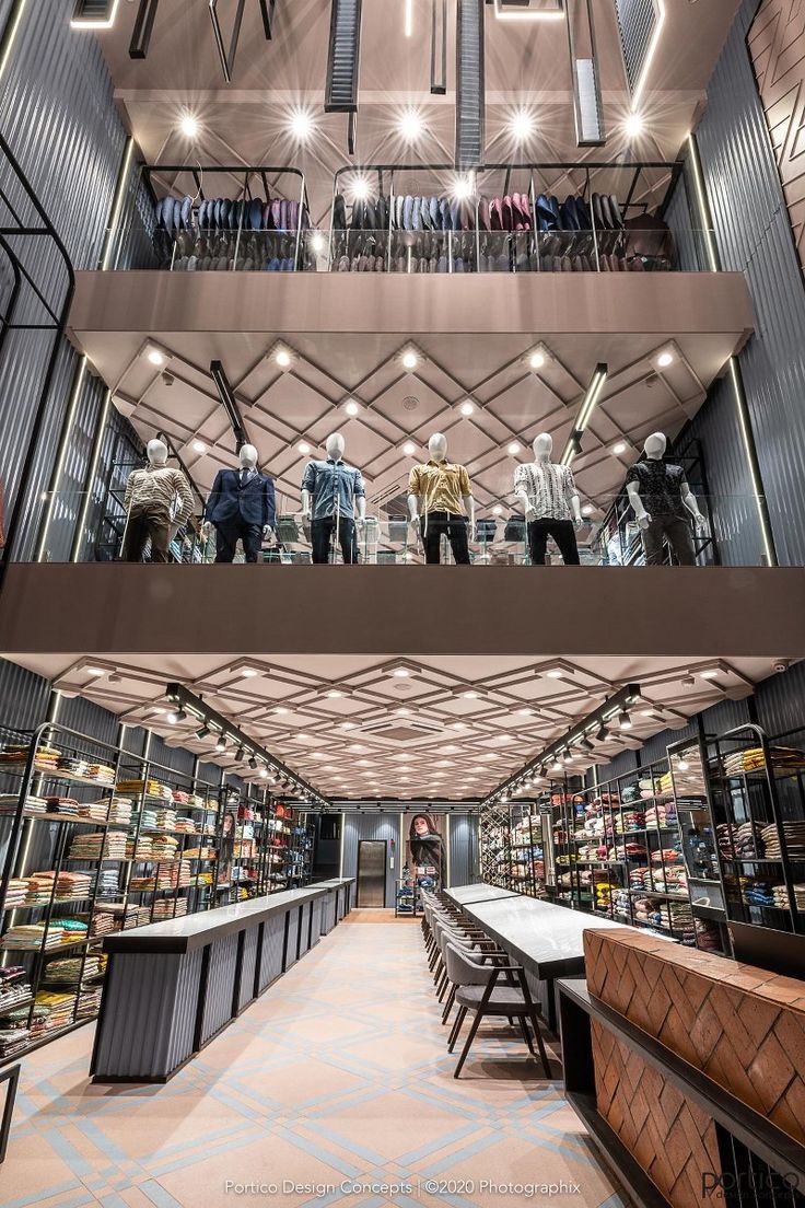 the inside of a store with several shelves filled with items and people standing in it