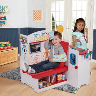 two children are playing with toys in a play room at the same time as they sit on their own chairs