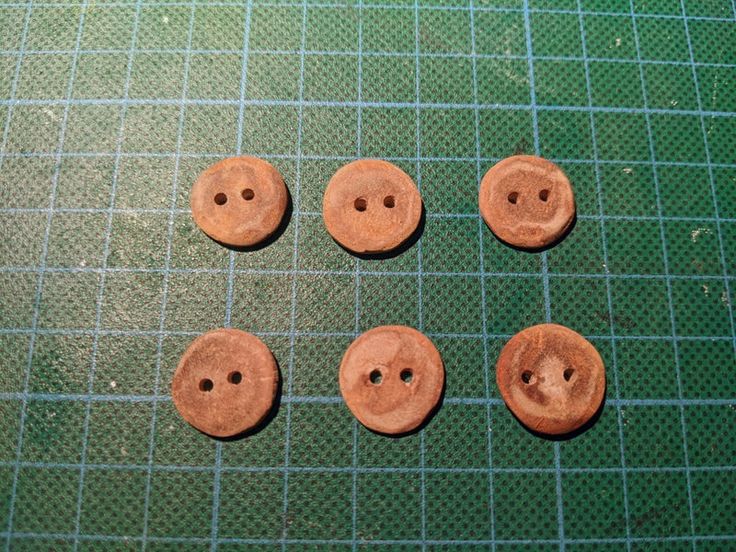 four wooden buttons sitting on top of a green mat