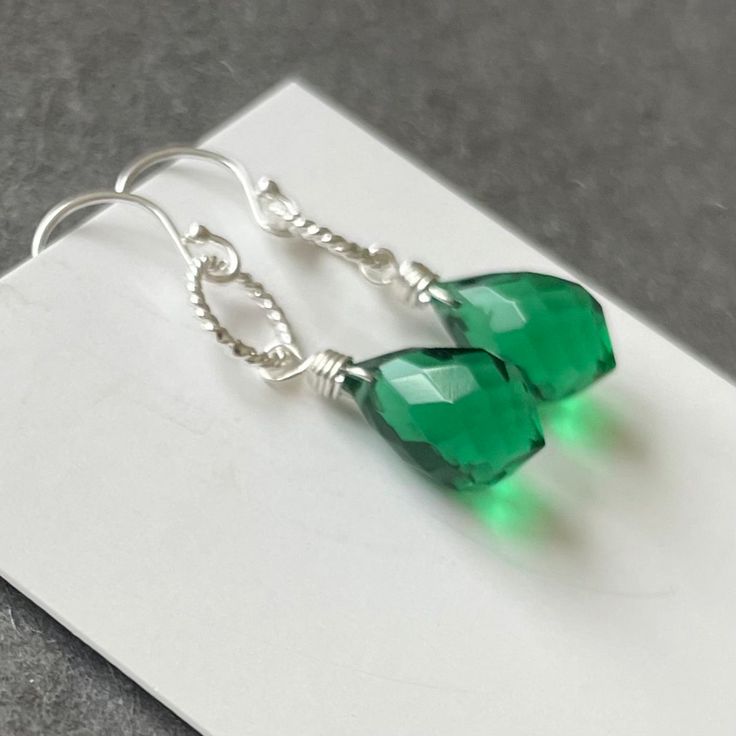 Fantastic plump dewdrop emerald green Quartz. The ultimate in color and sparkle. This stones is 12mm high, so it's not tiny. Sterling silver Hoop. Please choose your earwire ( options available exclusively at shirzay.com ) or the default French ball hook in sterling silver shown will be sent. APPRX. Length is 1 5/16”. Your jewelry will be beautifully giftboxed. Green Jewelry With Ear Wire For May Birthstone, Green Teardrop Birthstone Earrings, Hypoallergenic Green Teardrop Jewelry, Nickel-free Green Sterling Silver Crystal Earrings, Nickel-free Green Crystal Earrings In Sterling Silver, Green Nickel-free Teardrop Drop Earrings, Green Sterling Silver Crystal Earrings, Green Teardrop Sterling Silver Jewelry, Green Teardrop Drop Earrings Nickel Free