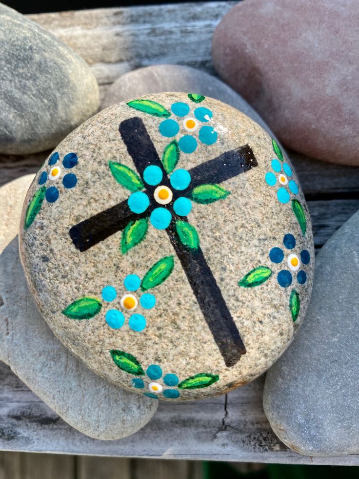 a painted rock sitting on top of a wooden bench