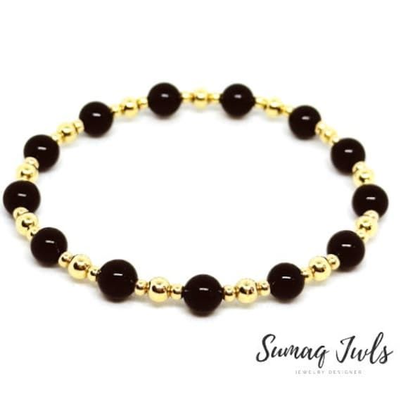 REAL 14K Gold Filled Beads (NOT PLATED, WILL NOT TARNISH) - These bracelets are made with high-quality gold-filled beads, lightweight, easy to wear, and so comfortable that you can sleep and shower in them.  Minimalist & Timeless Design. Great for Layering & Stacking. Handmade with love * 14k Gold Filled (high quality made in the USA). * Available in more colors.  * Classic, reliable, and go-to bracelet. * Made with2mm, 4mm 14k gold-filled beads and 6mm Gemstone. * Worry-free wear. * 1mm round elastic cord. * Stacks well with all bracelets. These bracelets are perfect alone or to accent your other bracelets, I personally source and assemble all my Jewelry Pieces with love. My Gold Filled jewelry is made with 8 layers of finishing in 14K Gold. Each item is manufactured to the highest qualit Gold Rosary Bracelet With Black Beads As Gift, Rosary Bracelet With Gold Round Beads As Gift, Elegant Rosary Bracelet With 8mm Beads For Jewelry Making, Gold Crystal Bracelet With Round Black Beads, Gold Beaded Bracelets With Gemstone, Yellow Gold Bracelets With Black Beads As Gift, Yellow Gold Bracelets With Black Beads For Gift, Yellow Gold Bracelet With Black Beads As Gift, Gold Crystal Bracelet With Gemstone Beads