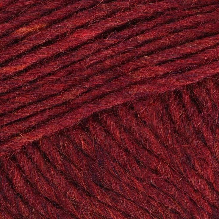 red yarn is shown in this close up photo, it looks to be very soft