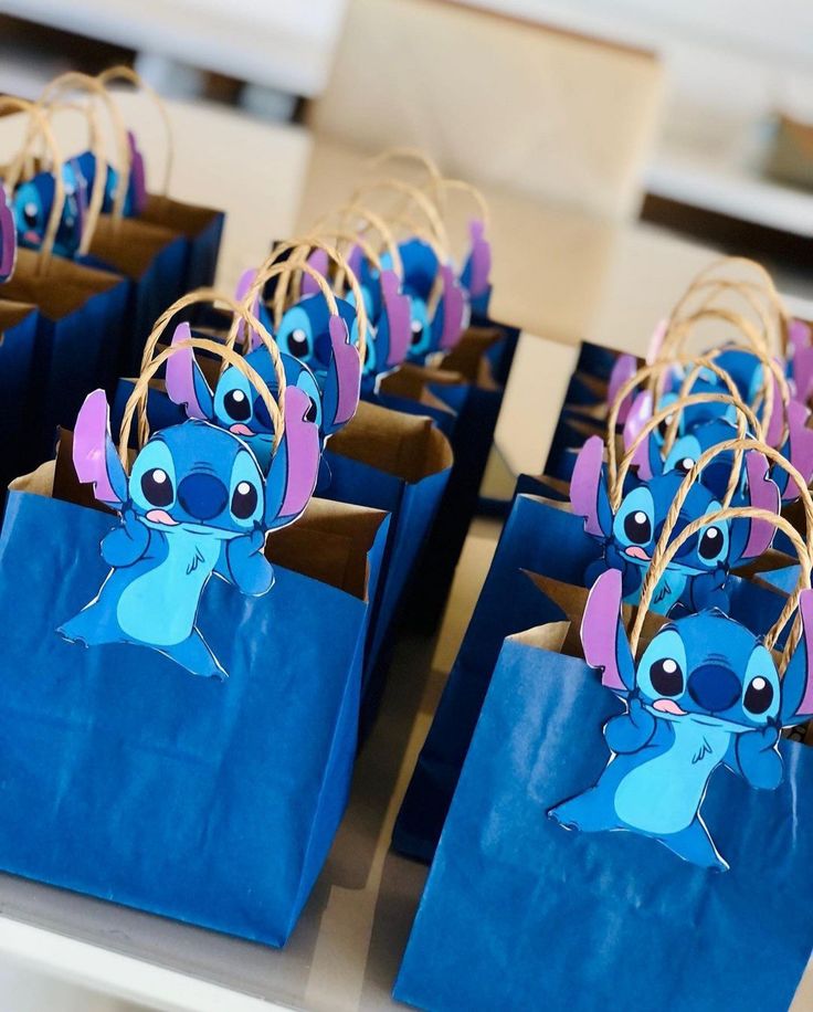 small blue bags with cartoon characters on them are sitting on a table, ready to be eaten