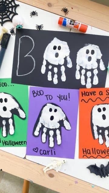 handprinted halloween cards on a table with crayons