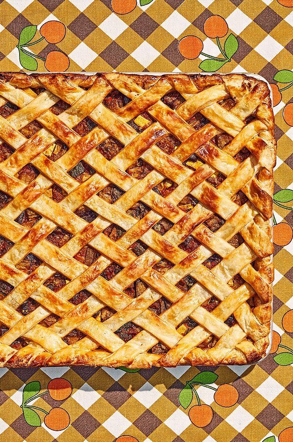 an apple pie on a checkered table cloth