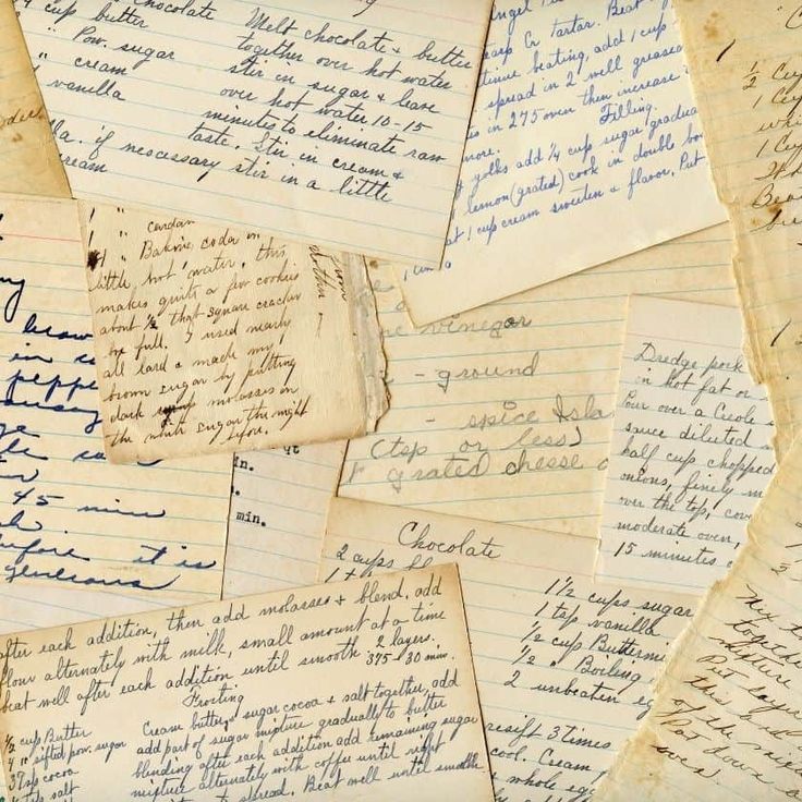 many old handwritten notes are stacked on top of each other