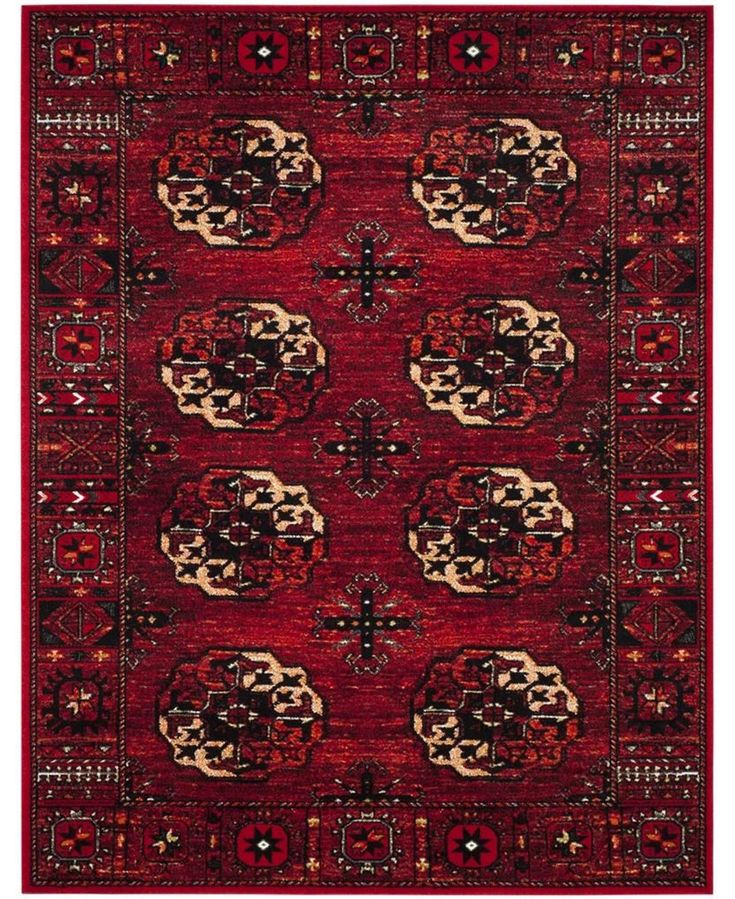 a red area rug with an intricate design on the center and sides, in different colors