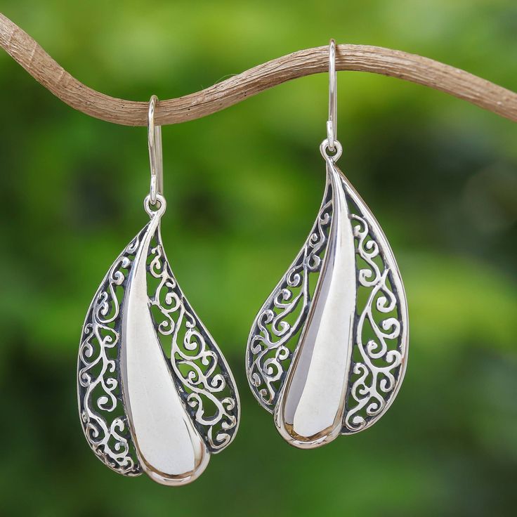 This stunning pair of sterling silver dangle earrings is from the creative mind of artisan Rattiya Chaiwong. The Thai artisan creates each earring in a beautiful leaf shape, with gorgeous openwork bordering a sleek silver center. Rattiya is inspired by the wonderful creations of the hill tribe people in her elegant design. Artisan Teardrop Pierced Earrings, Sterling Silver Drop Earrings With Intricate Design, White Intricate Design Danglers As Gift, White Intricate Danglers For Gift, Artisan Drop Earrings, White Danglers With Intricate Design For Gift, Artisan Silver Teardrop Earrings, Artisan Sterling Silver Teardrop Dangle Earrings, White Teardrop Earrings With Intricate Design