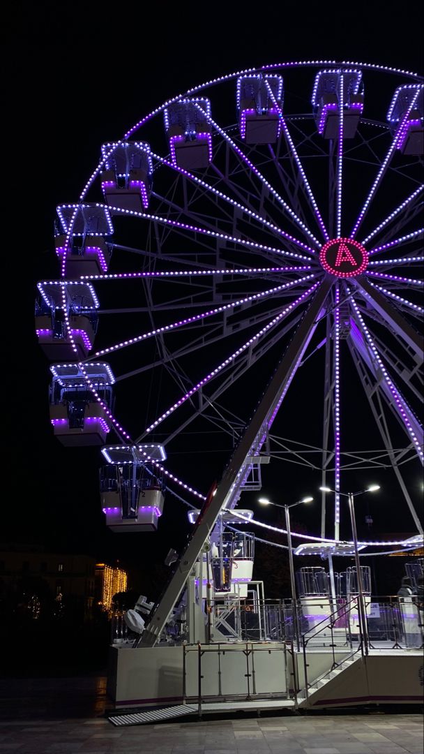 a large ferris wheel lit up at night