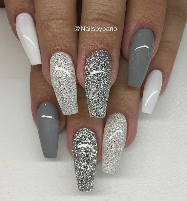 a manicure with silver and white glitters on the tip of each nail is shown