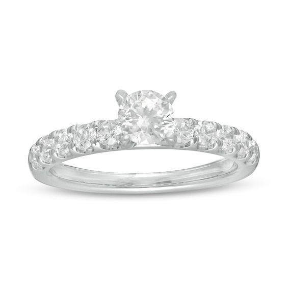 With eye-catching sparkle, this diamond engagement ring is anything but ordinary. Crafted in cool 10K white gold, this timeless choice features a 1/2 ct. diamond atop a bold diamond-lined shank. The inside of the shank is rounded for all-day comfort. Captivating with 1 ct. t.w. of diamonds and a brilliant buffed luster, this engagement ring simply dazzles. White Solitaire Halo Ring, White Round Cut Halo Ring With Lab Grown Diamonds, White Lab Grown Diamond Halo Ring With Round Cut, White Lab Grown Diamond Round Cut Halo Ring, White Diamond Cluster Ring With Brilliant Cut, White Round Diamond Ring With Center Stone, White Brilliant Cut Diamond Cluster Ring, Dazzling White Halo Ring With Prong Setting, White Cluster Ring With Diamond Accents In Moissanite