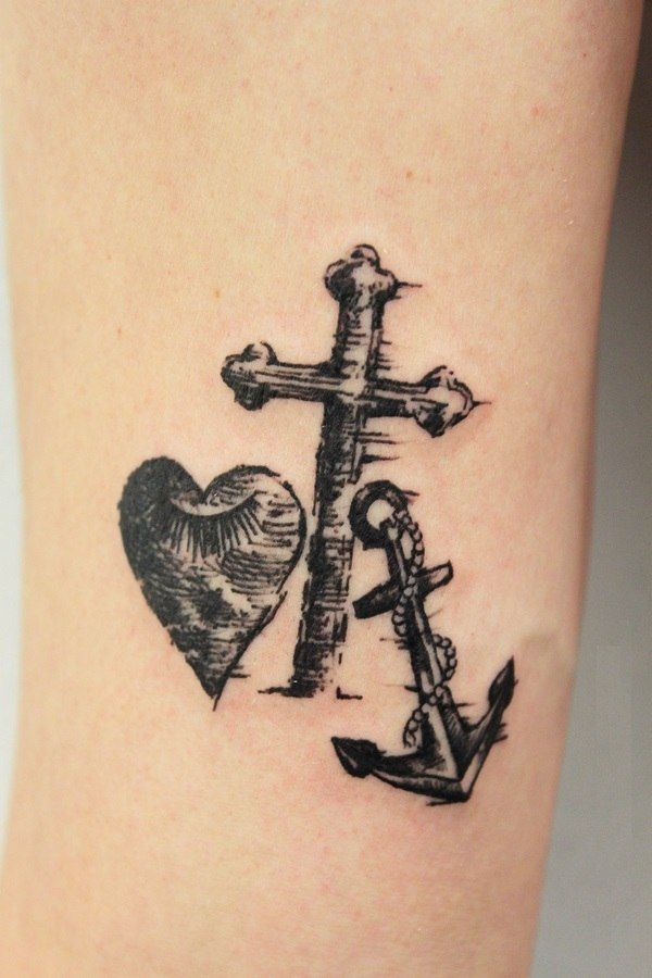 a cross and anchor tattoo on the ankle with a heart in the middle is shown