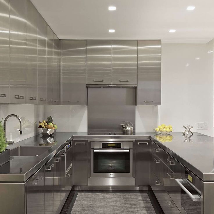 a modern kitchen with stainless steel appliances and counter tops