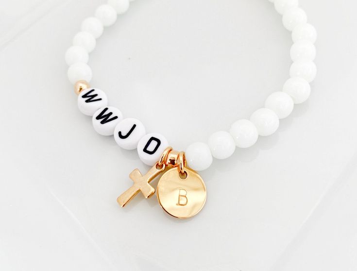 WWJD bead bracelet, What would Jesus do, Religious bracelet, Confirmation gift, Baptism gift, First Communion gift, Christian jewelry MATERIAL*DIMENSIONS*DETAILS Acrylic gum ball beads - 6mm Acrylic letter beads - 7mm Gold Electroplate stainless steel beads and cross charm OPTION MENUS Select bracelet size Select bead color All our jewelry and gifts are custom made and are packaged in complimentary gift boxes. Everything ships in 1-3 business days. Thanks so much for stopping by & God Bless! Homemade Christian Bracelets, Bible Beaded Bracelets, Christian Bead Bracelets Diy, Cute Christian Jewelry, Cross Clay Bead Bracelet, Christian Beaded Jewelry, Wwjd Bracelet Aesthetic, Christan Gifts, Gifts For Christian Friends