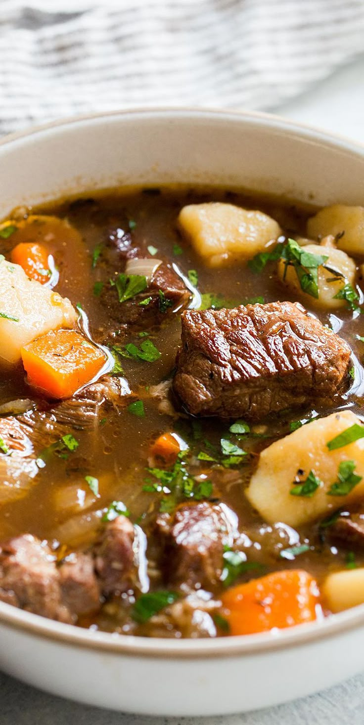 a bowl of beef stew with potatoes and carrots