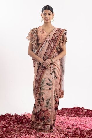 Peach saree with all over floral blossom prints and embroidered border. Paired with a padded, coordinating blouse. Comes along with a petticoat. - Aza Fashions Silk Floral Print Blouse Piece For Reception, Unstitched Saree With Floral Print For Reception, Unstitched Floral Print Saree For Reception, Silk Blouse With Floral Print For Wedding, Bohemian Blouse With Printed Motifs For Weddings, Bohemian Designer Saree With Floral Print, Bollywood Style Pre-draped Floral Saree For Wedding, Festive Pre-draped Saree With Floral Print For Reception, Festive Floral Print Saree For Transitional Season