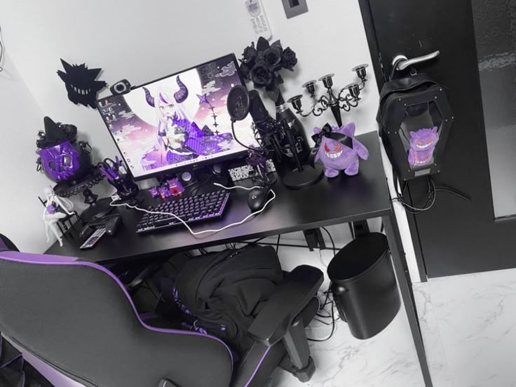 a desk with a computer on top of it and purple decorations around the table in front of it